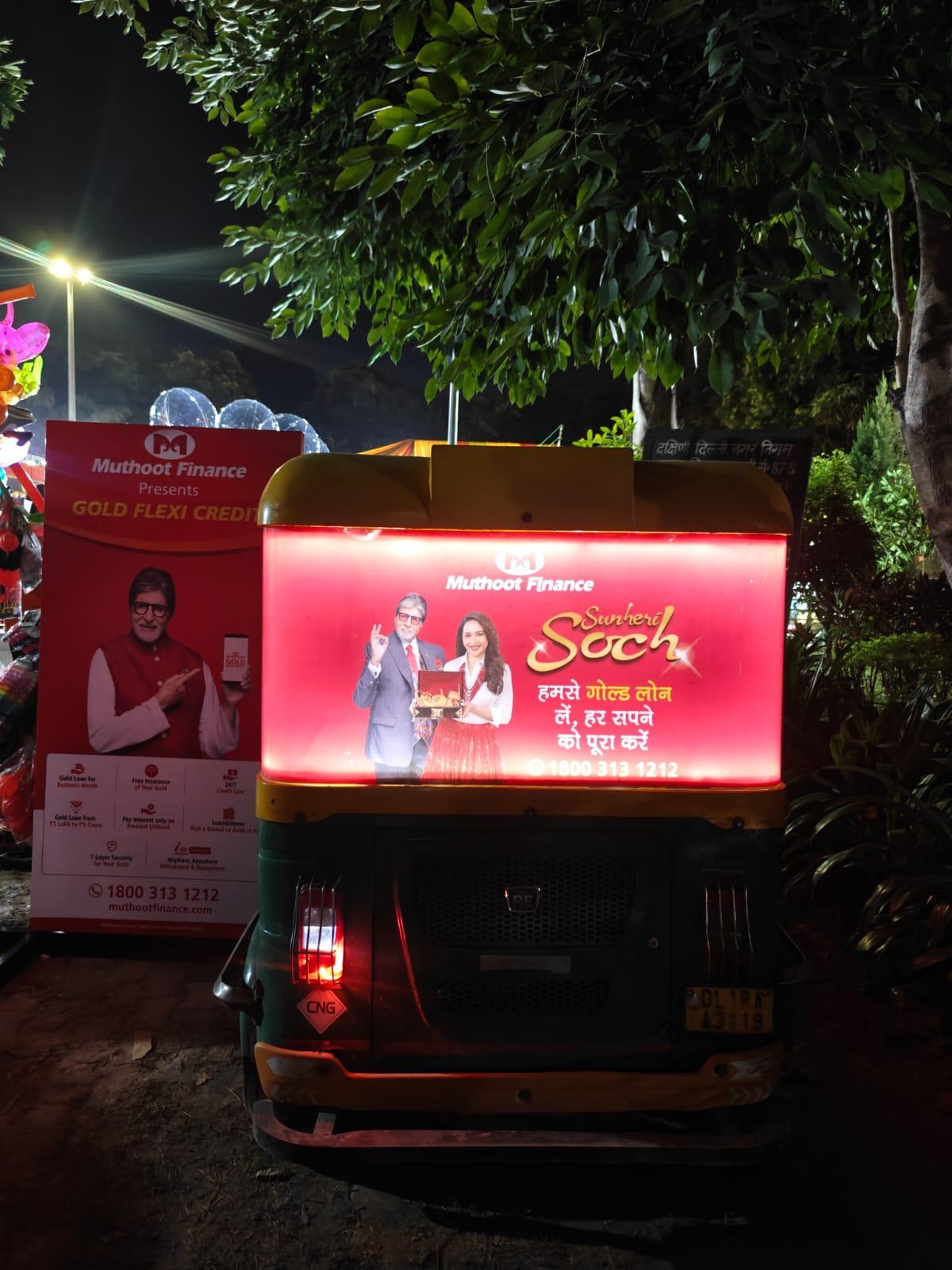 Close-up of backlit auto-rickshaw ad, Muthoot Finance